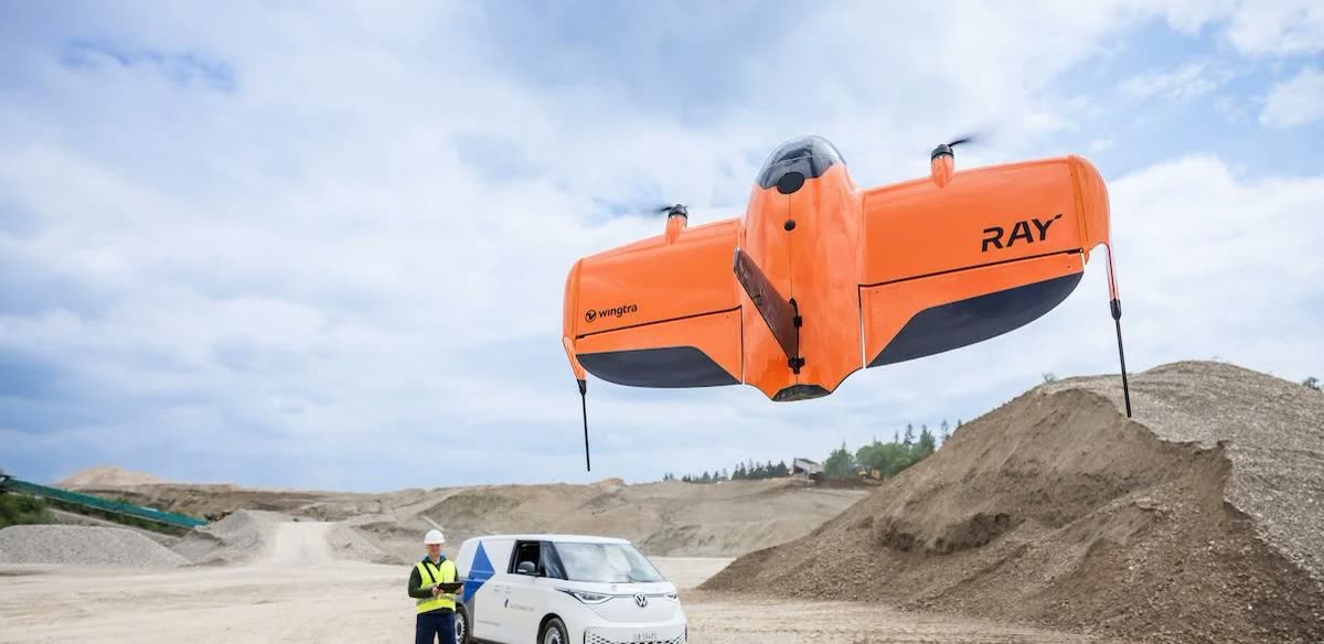 Wingtra Ray launching vertically from a construction site