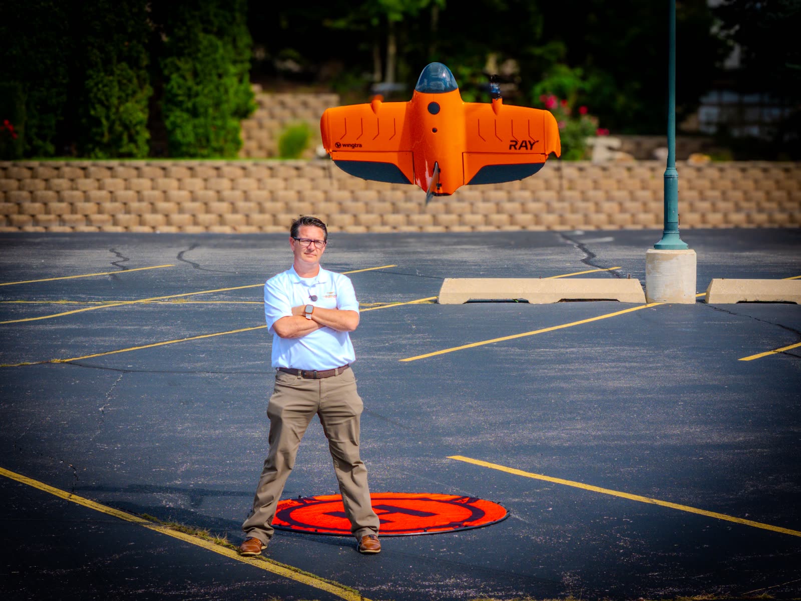 Operator standing beside a Wingtra VTOL aircraft before launch