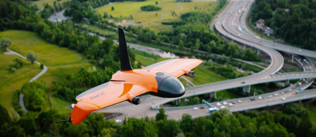 Wingtra Ray in cruise flight above a highway interchange