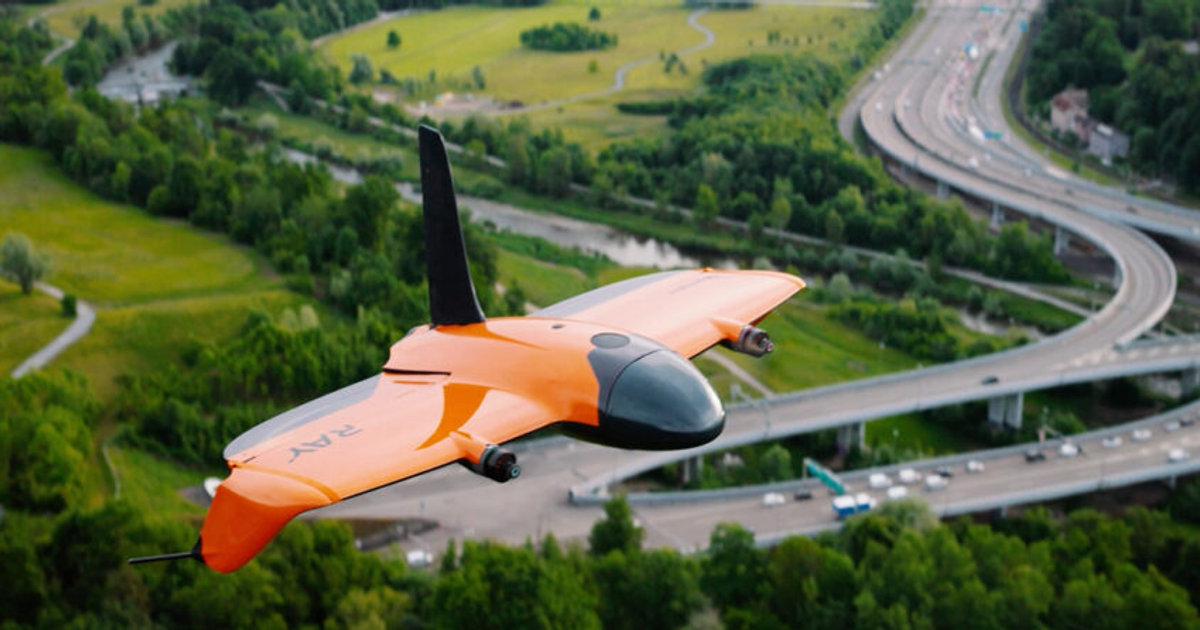 Wingtra Ray VTOL mapping drone flying over buildings and roads