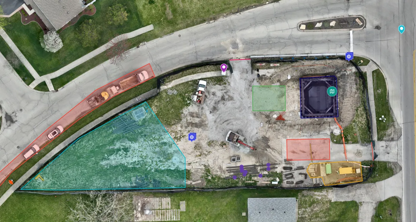 Overhead orthomosaic site plan with material storage and crane zones